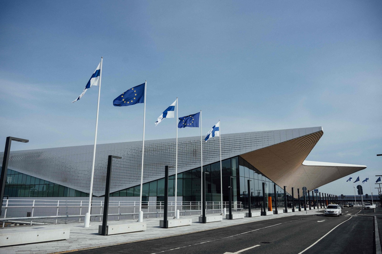 Finnish and EU flags wave outside of the Terminal 2 of the Helsinki airport, Vantaa, Finland, Aug. 19, 2022. (AFP Photo)