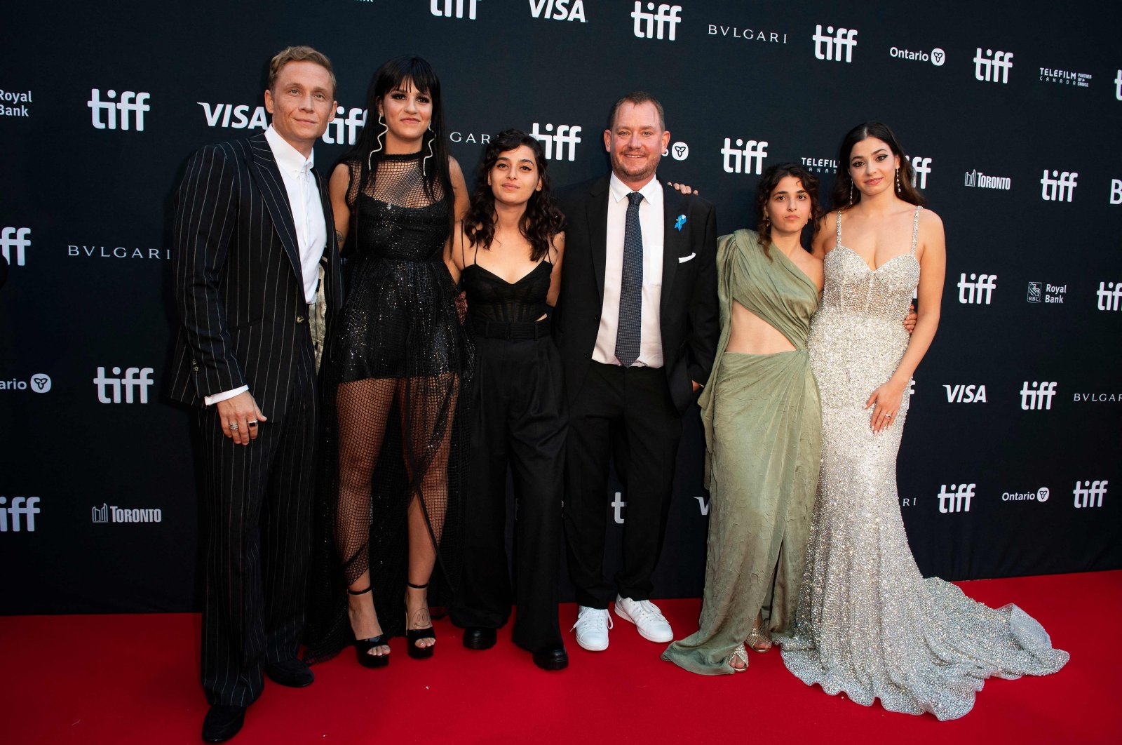 (From L) German actor Matthias Schweighofer, Syrian swimmer Sarah Mardini, French-Lebanese actress Manal Issa, swimm trainer Sven Spannekrebs  French-Lebanese actress Nathalie Issa, and Syrian swimmer Yusra Mardini arrive for &quot;The Swimmers&quot; premiere at Roy Thomson Hall during the opening night of the Toronto International Film Festival in Toronto, Ontario, Canada, Sept. 8, 2022. (AFP Photo)