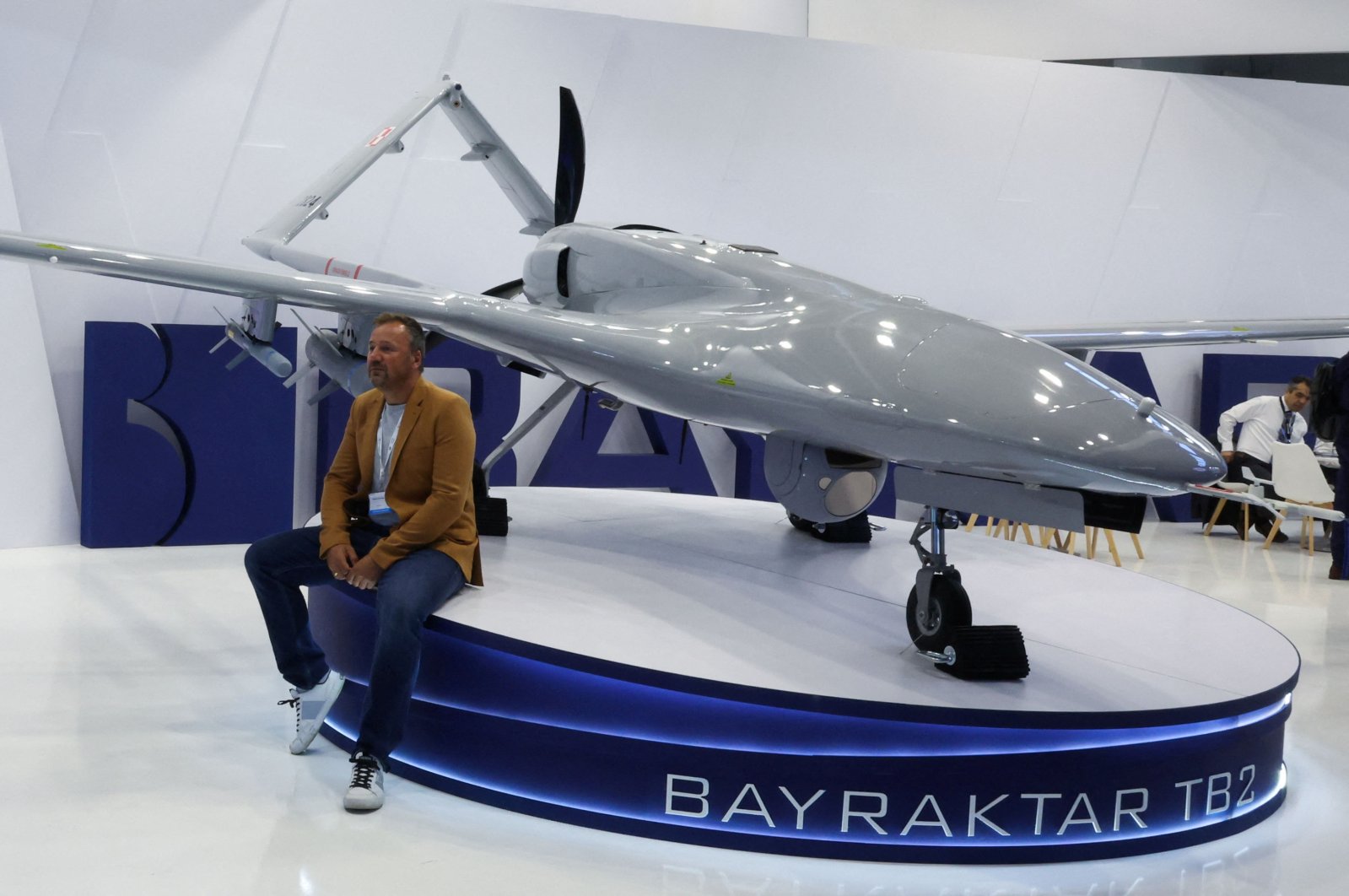 A man poses for a picture near a Turkish Bayraktar TB2 drone inside a hall of the 30th international Defence Industry Exhibition in Kielce, Poland, Sept. 5, 2022. (Reuters Photo)