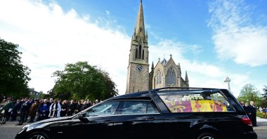 Members of the Public pay their respects as the hearse carrying the coffin of Queen Elizabeth II is driven through Ballater, Scotland, Sept. 11, 2022. (AFP Photo)