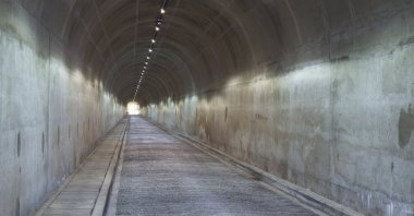 A long concrete tunnel leads down underneath a dam wall in South Africa (shutterstock)