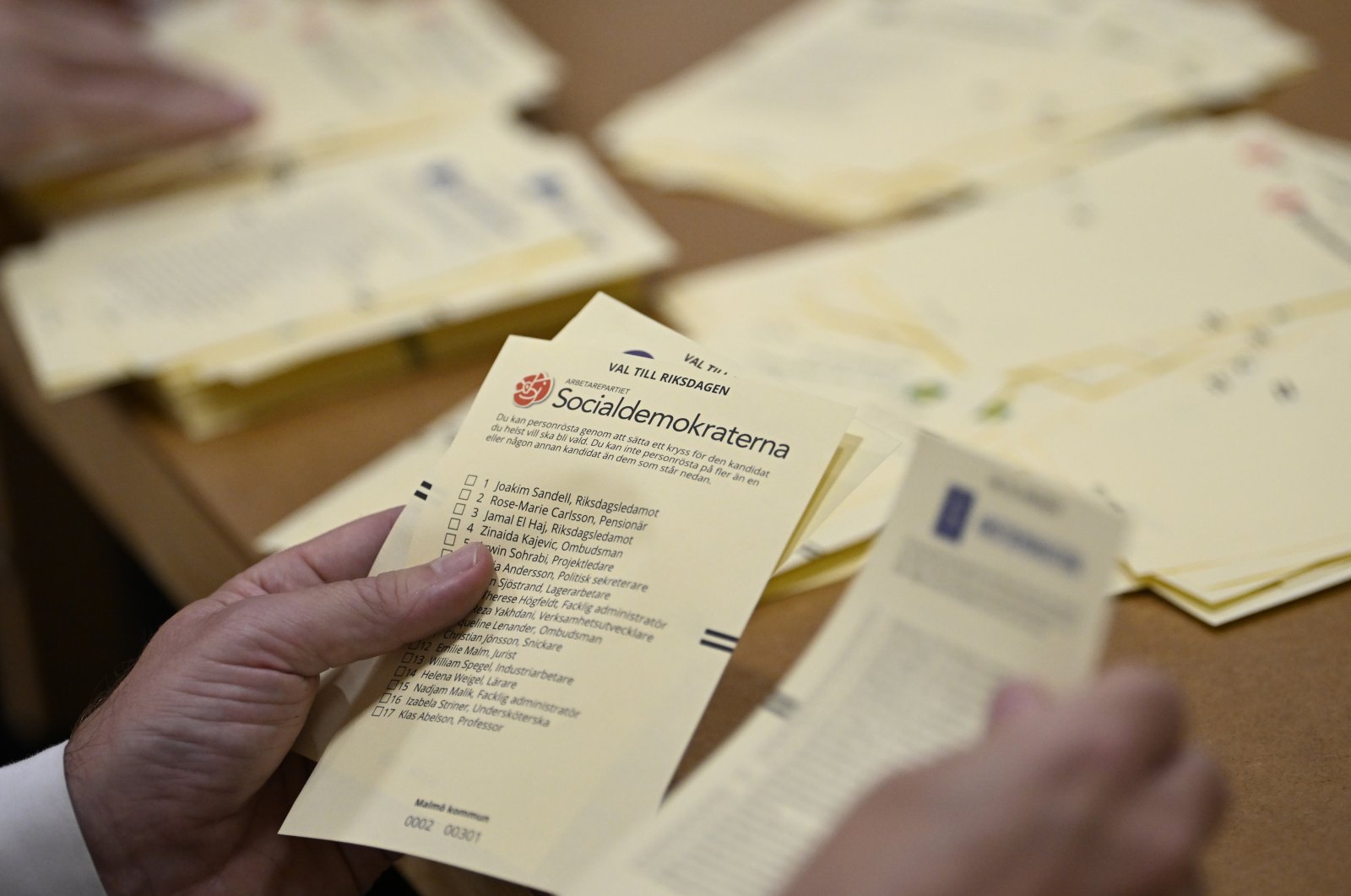Poll workers count votes at a polling station at Hästhagens Sport Center in Malmö, Sweden, Sunday, Sept. 11, 2022. (Johan Nilsson/TT News Agency via AP)