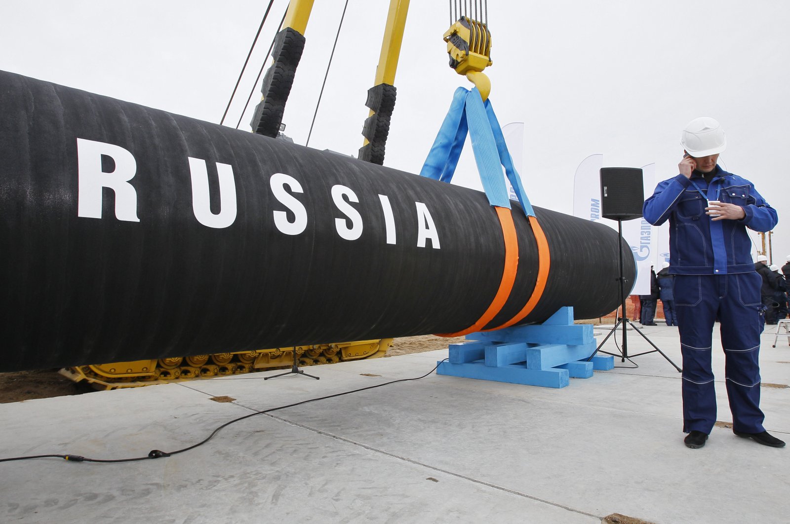 A Russian construction worker speaks on a mobile phone during a ceremony marking the start of the Nord Stream pipeline construction in Portovaya Bay northwest of St. Petersburg, Russia, April 9, 2010. (AP File Photo)
