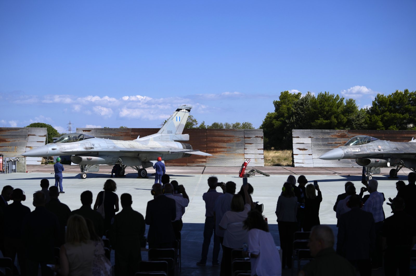 Guests take photographs of the two Greek fighter jets F-16 Vipers at Tanagra air force base about 74 kilometers (46 miles) north of Athens, Greece, Sept. 12, 2022. (AP Photo)