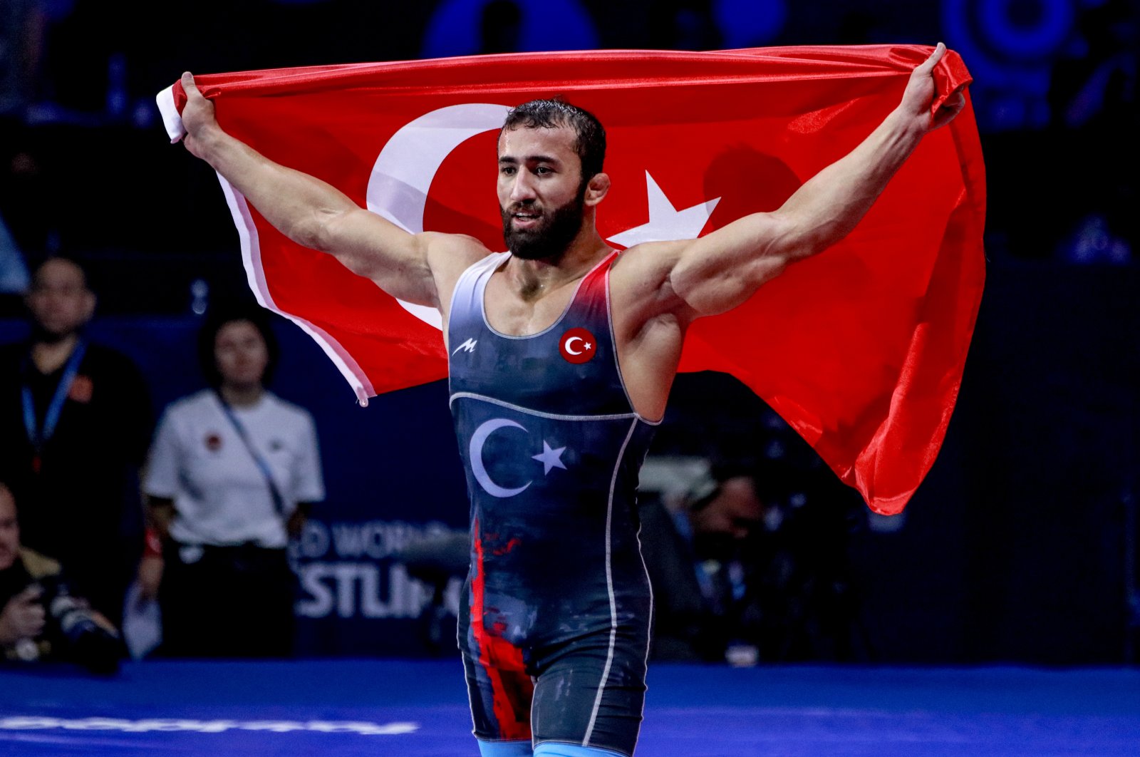 Burhan Akbudak of Türkiye celebrates by waving a national flag after winning gold in the men’s Greco-Roman 82 kg category at the World Wrestling Championships, Belgrade, Serbia, Sept. 12, 2022. (AA Photo)