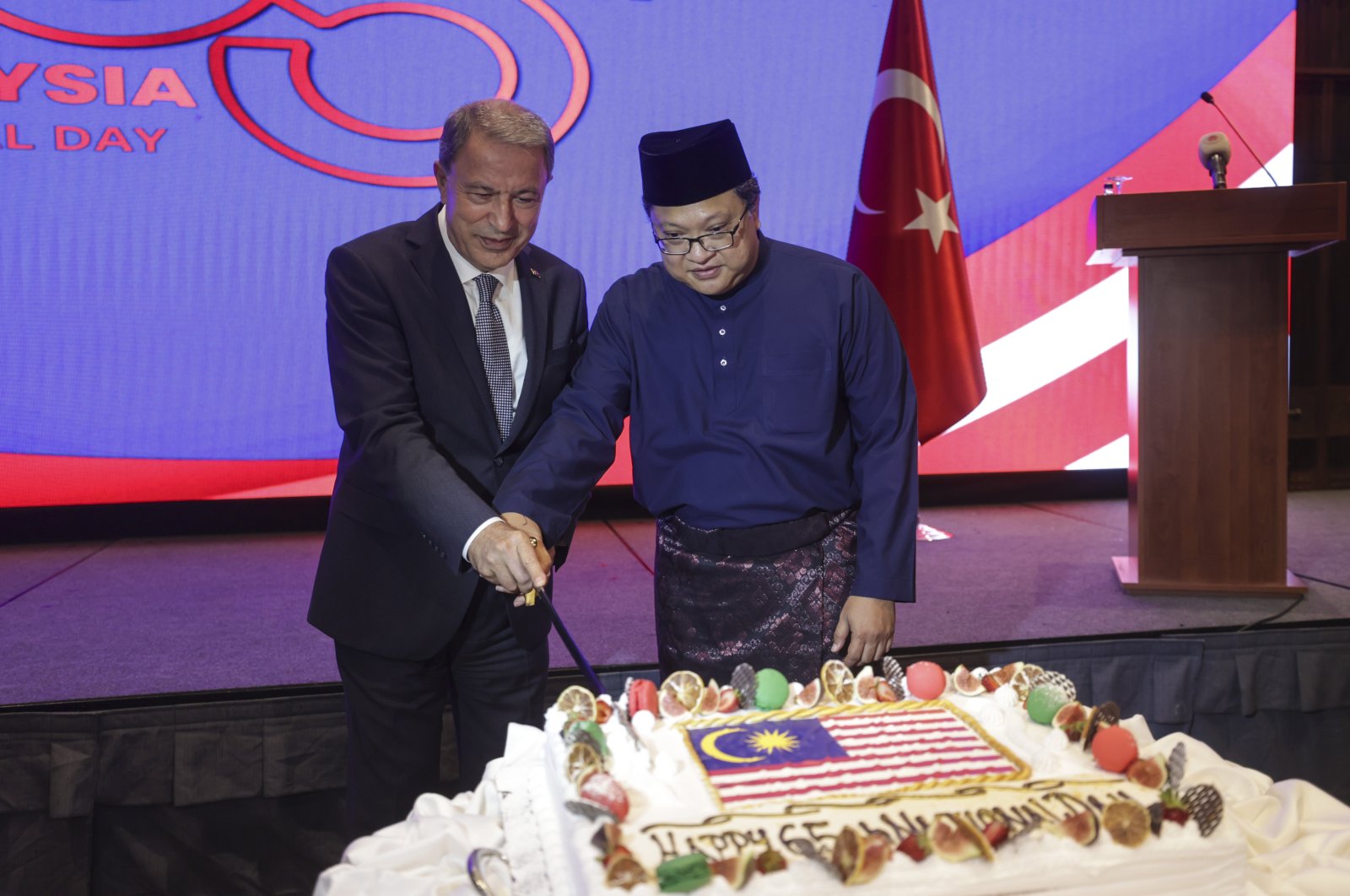 Turkish Defense Minister Hulusi Akar (L) attends the reception hosted by Malaysian Ambassador Sazali Bin Mustafa Kamal (R) to mark the 65th anniversary of Malaysia&#039;s independence in Ankara, Türkiye, Sept. 12, 2022. (AA Photo)