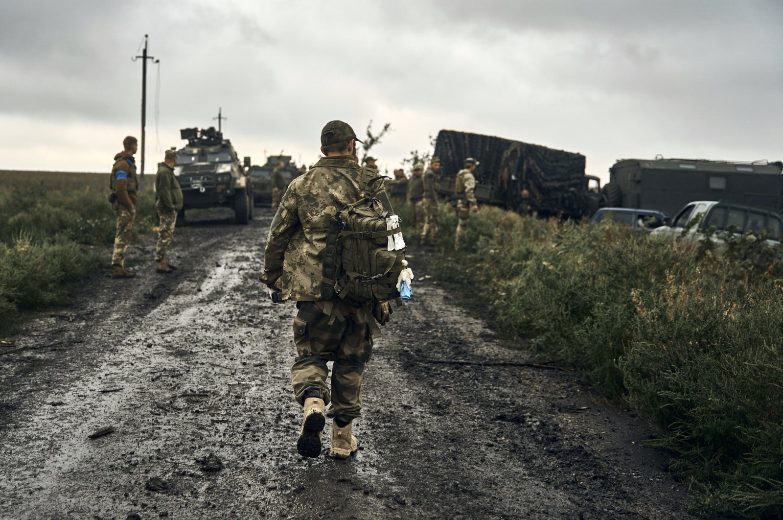 Ukrainian soldiers stand on the road in the freed territory of the Kharkiv region, Ukraine, Sept. 12, 2022. (AP Photo)