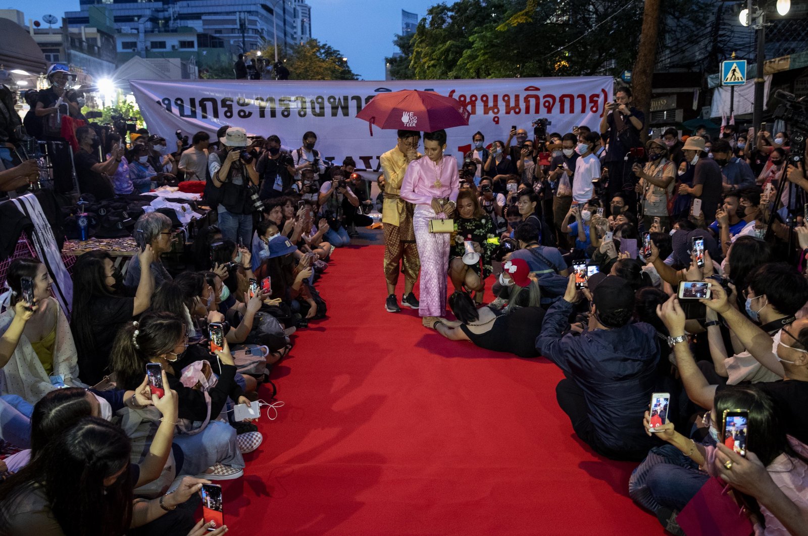 Pro-democracy protesters perform on a mock &quot;red carpet&quot; fashion show billed as a sort of counterpoint to a fashion show being held by one of the monarchy&#039;s princesses nearby in Bangkok, Thailand, Oct. 29, 2020. (AP Photo)