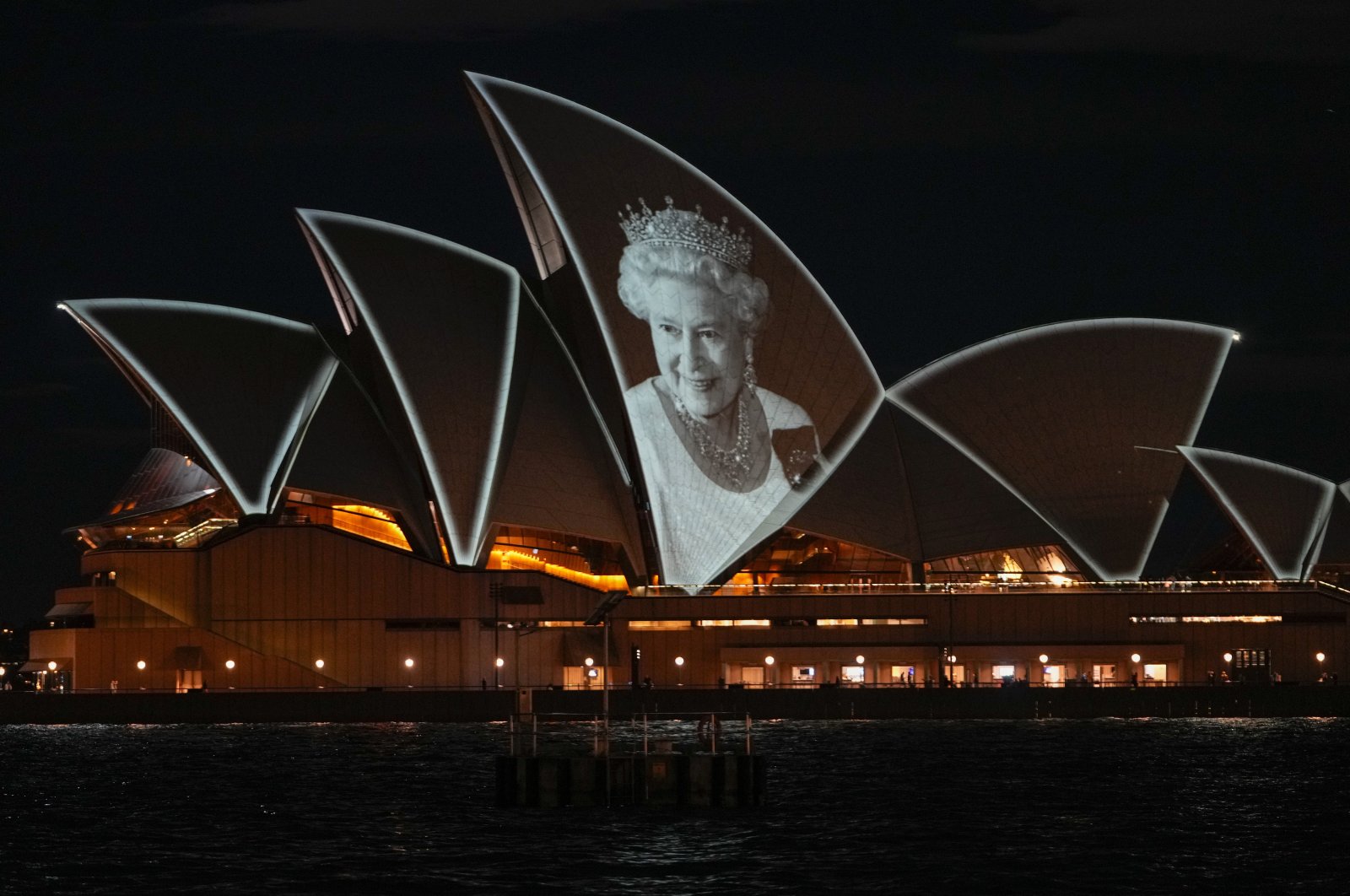 The Sydney Opera House is illuminated with a portrait of Queen Elizabeth II in Sydney, Australia, Sept. 9, 2022. (AP Photo)