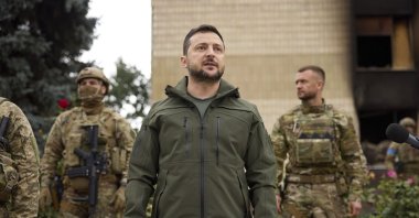 Ukrainian President Volodymyr Zelenskyy, center, is surrounded by soldiers during his visit in Izium, Kharkiv region, Ukraine, Sept. 14, 2022. (Ukrainian Presidential Press Office via AP)