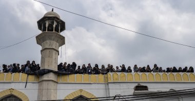 Muslim women watch an Ashura procession from the roof of a mosque in New Delhi, India, Aug. 9, 2022. (AP File Photo)