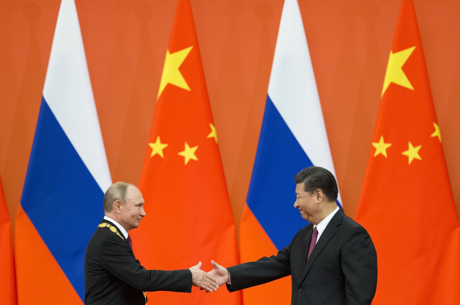 Chinese President Xi Jinping (R) and Russian President Vladimir Putin shake hands during an award ceremony at the Great Hall of the People in Beijing, China, June 8, 2018. (AP Photo)