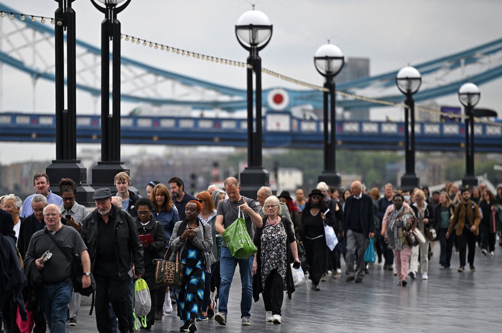 Members of the public stand in the queue on the South Bank of the River Thames, near Tower Bridge, as they wait in line to pay their respects to the late Queen Elizabeth II, in London, U.K. Sept. 15, 2022. (AFP Photo)