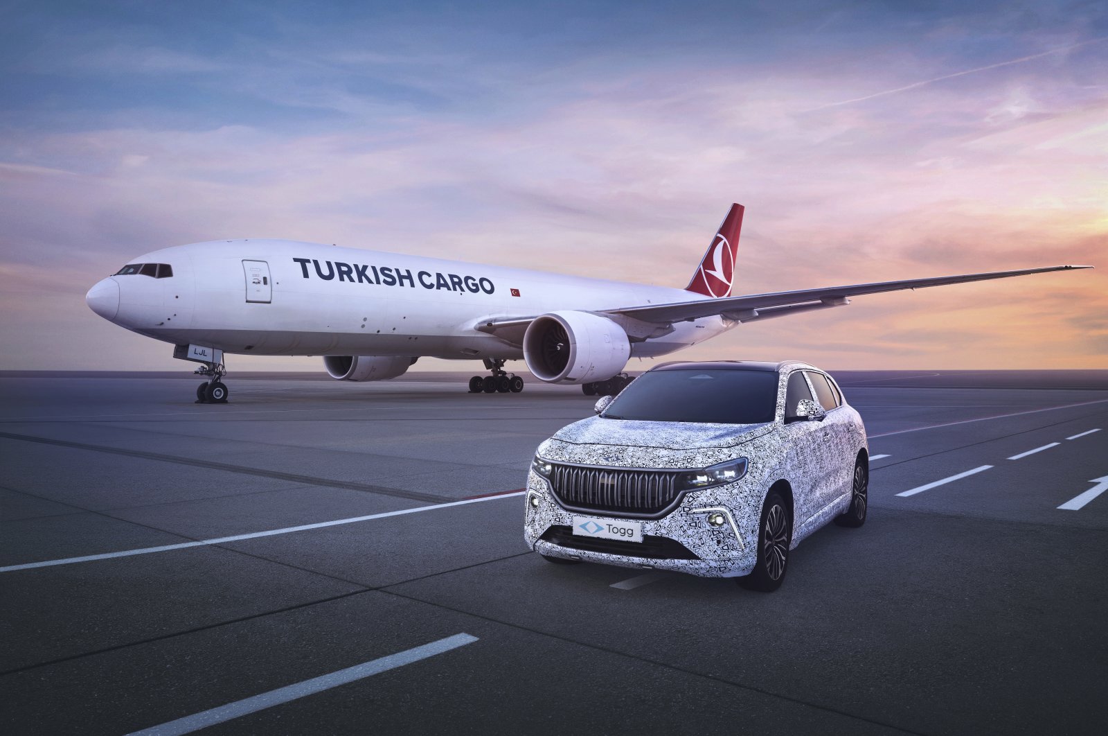 This illustration photo shows a Togg SUV model alongside a Turkish cargo plane. (AA Photo)