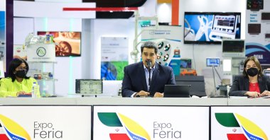 Venezuela's President Nicolas Maduro (C) speaking next to Vice-President Delcy Rodriguez (L) and Minister of Science and Technology Gabriela Jimenez during the opening ceremony of the Iran-Venezuela Industrial Scientific and Technological Expoferia, at the Poliedro stadium in Caracas, Sept. 15, 2022. (Venezuelan Presidency / AFP)
