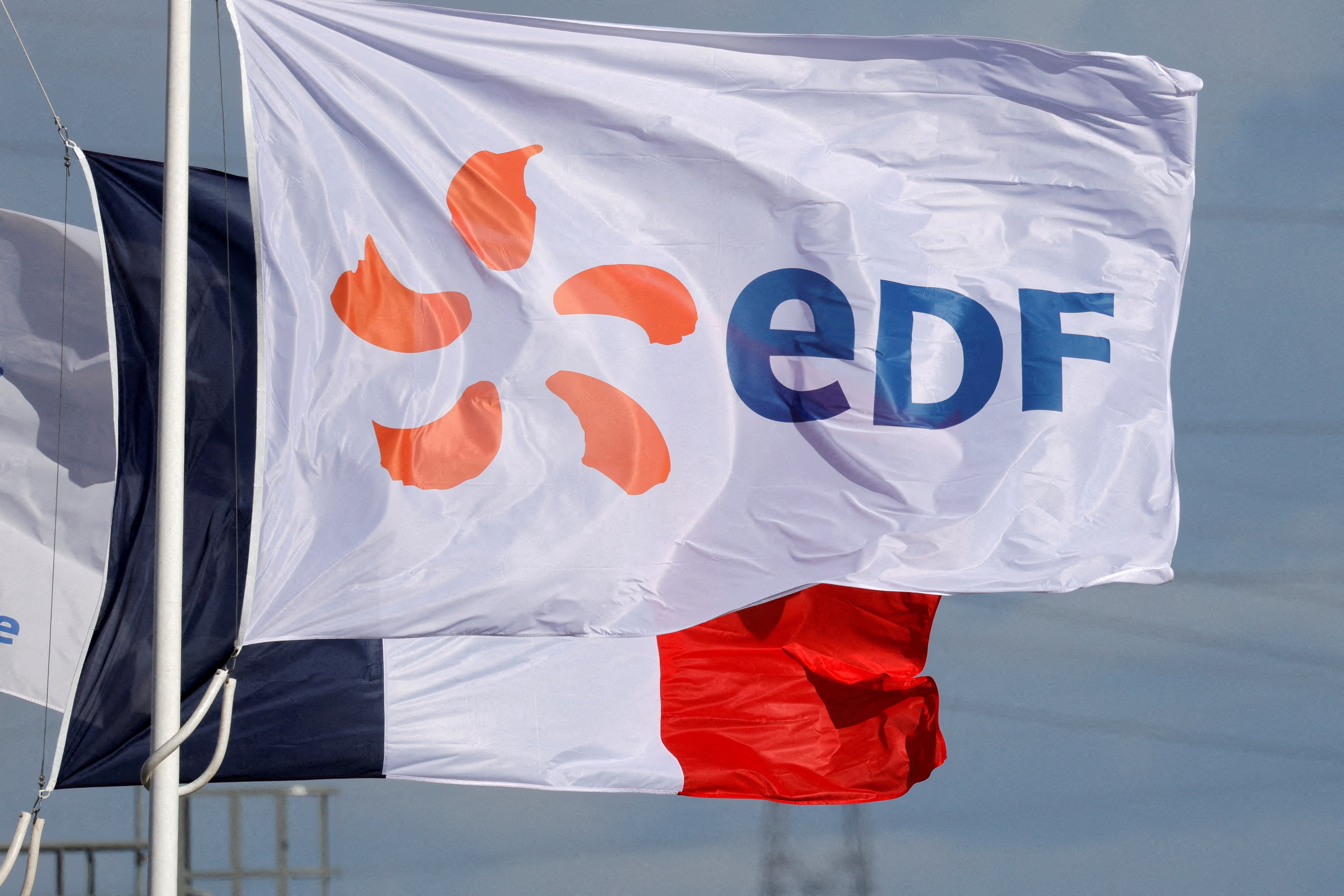  A flag with the company logo of Electricite de France (EDF) and a French flag fly next to the EDF power plant in Bouchain, near Valenciennes, France, Sept. 29, 2021. (REUTERS/Pascal Rossignol/File Photo)