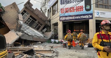 Firefighters in the search for trapped victims in a collapsed residential building following earthquake in Yuli township in Hualien County, eastern Taiwan, Sept. 18, 2022. (AP Photo)