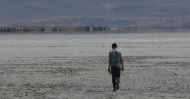 A man is seen walking on the dried-up Lake Seyfe, Kırşehir, central Türkiye, Sept. 18, 2022. (AA Photo)