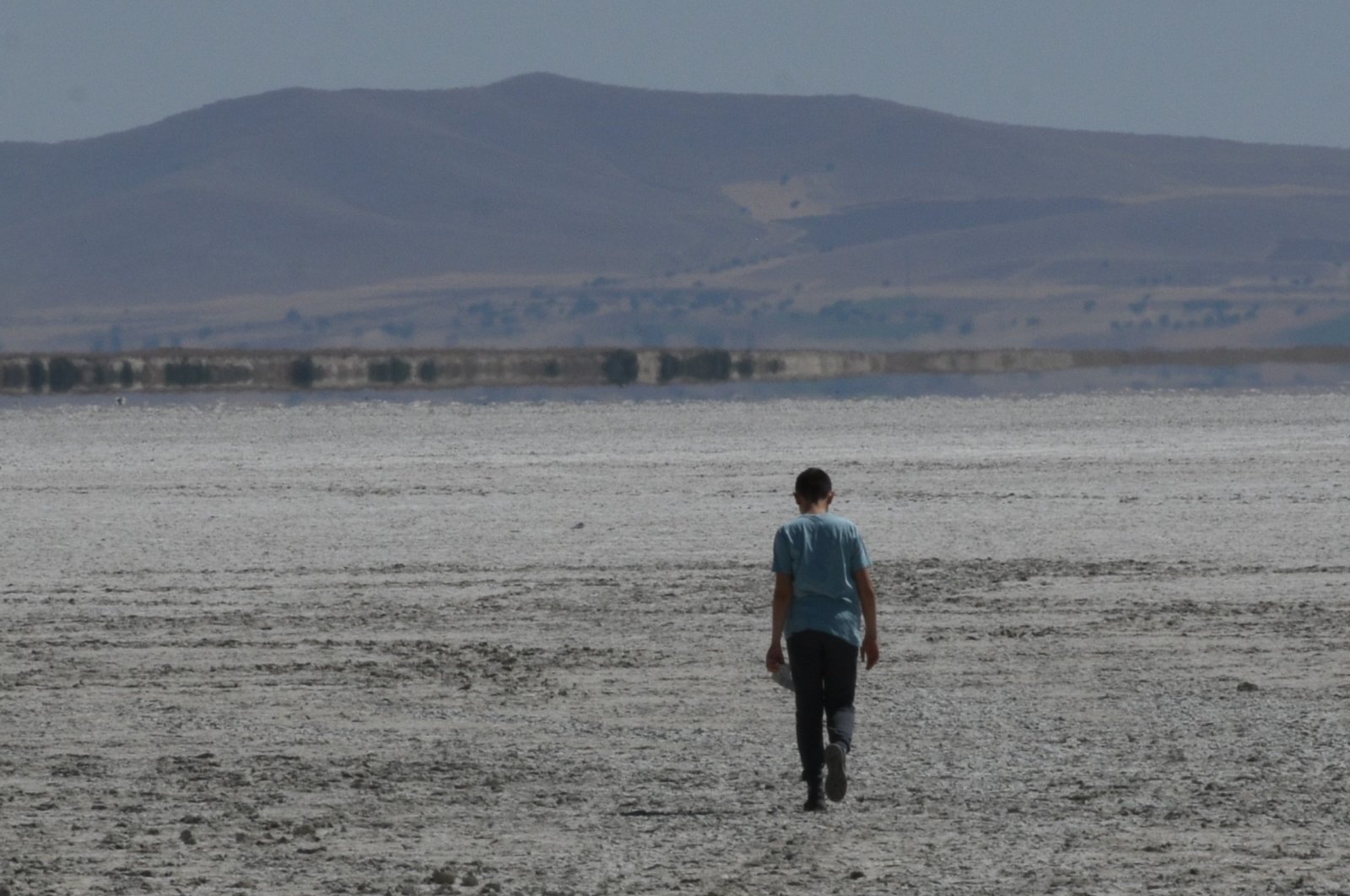 A man is seen walking on the dried-up Lake Seyfe, Kırşehir, central Türkiye, Sept. 18, 2022. (AA Photo)