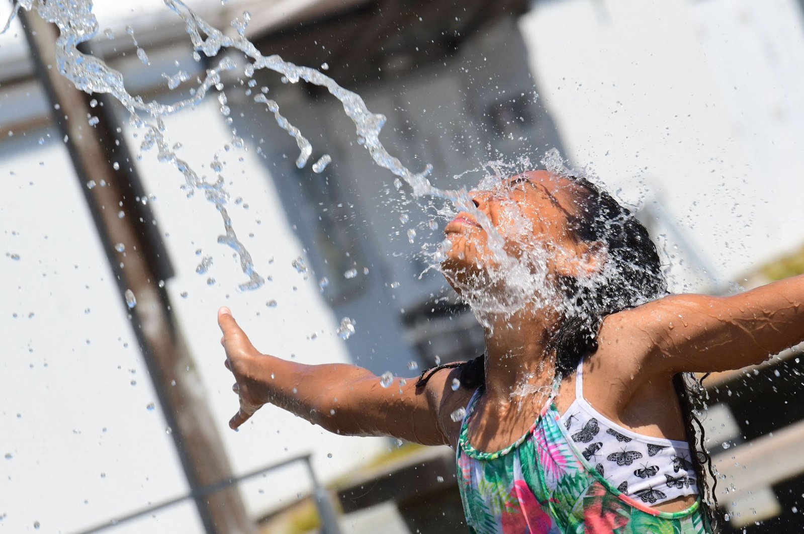 Kids cool off at a community water park on a scorching hot day in Richmond, British Columbia, Canada, June 29, 2021. (AFP Photo)