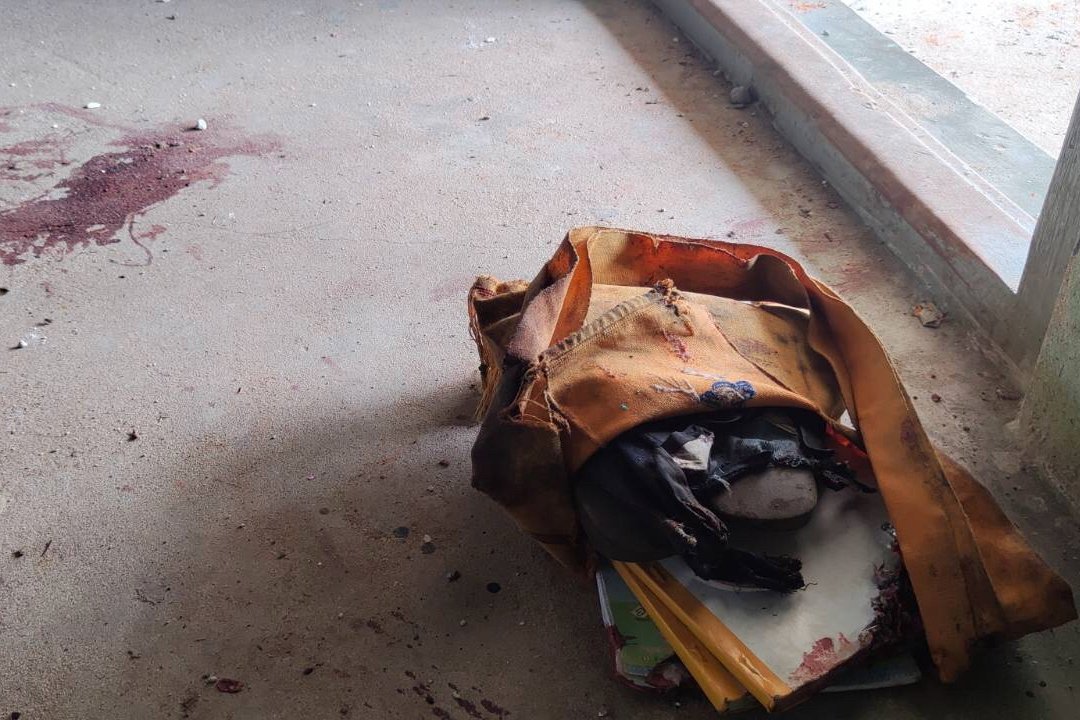 A school bag lies next to dried blood stains on the floor of a middle school in Let Yet Kone village in Tabayin township in the Sagaing region of Myanmar, Sept. 17, 2022. (AP Photo)