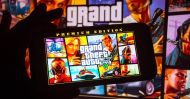 The Grand Theft Auto (GTA) logo is seen displayed on a smartphone in this photo illustration, Oct. 6, 2021. (Reuters Photo)