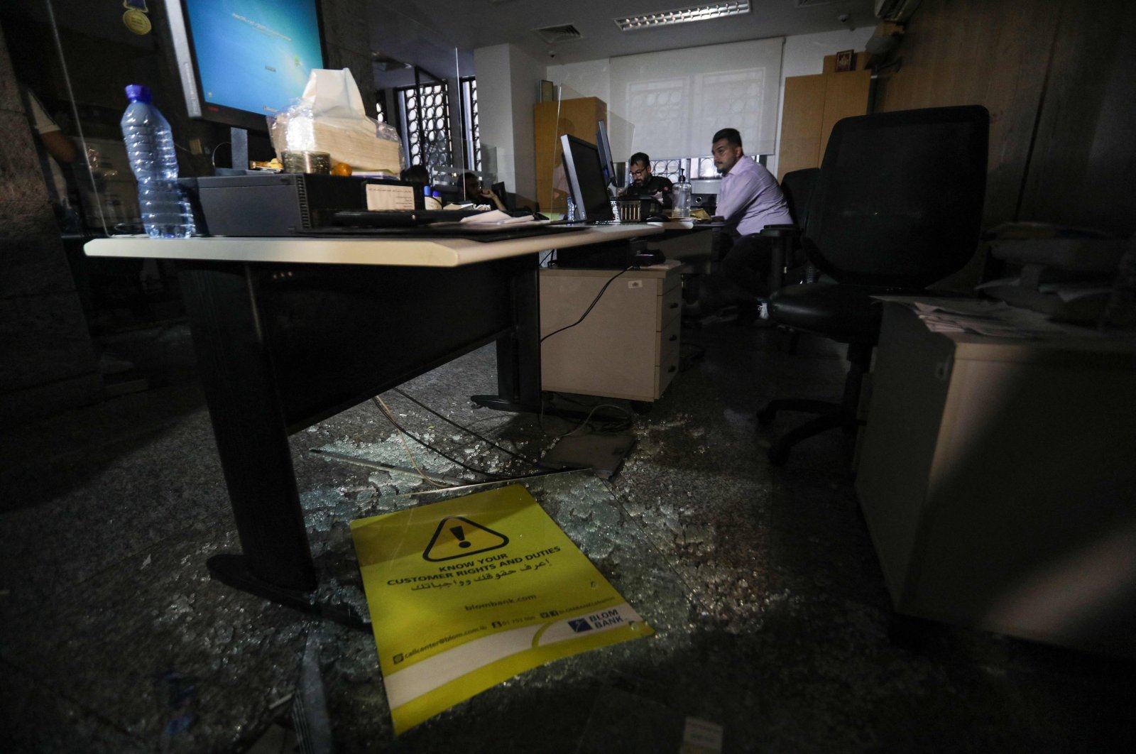 Broken glass is scattered on the floor of the Blom Bank branch in the Tariq al-Jdideh neighborhood, after depositor Abed Soubra stormed it, later surrendered his weapon to security forces and remained inside the bank demanding to withdraw his frozen savings, Beirut, Lebanon, Sept. 16, 2022. (AFP Photo)