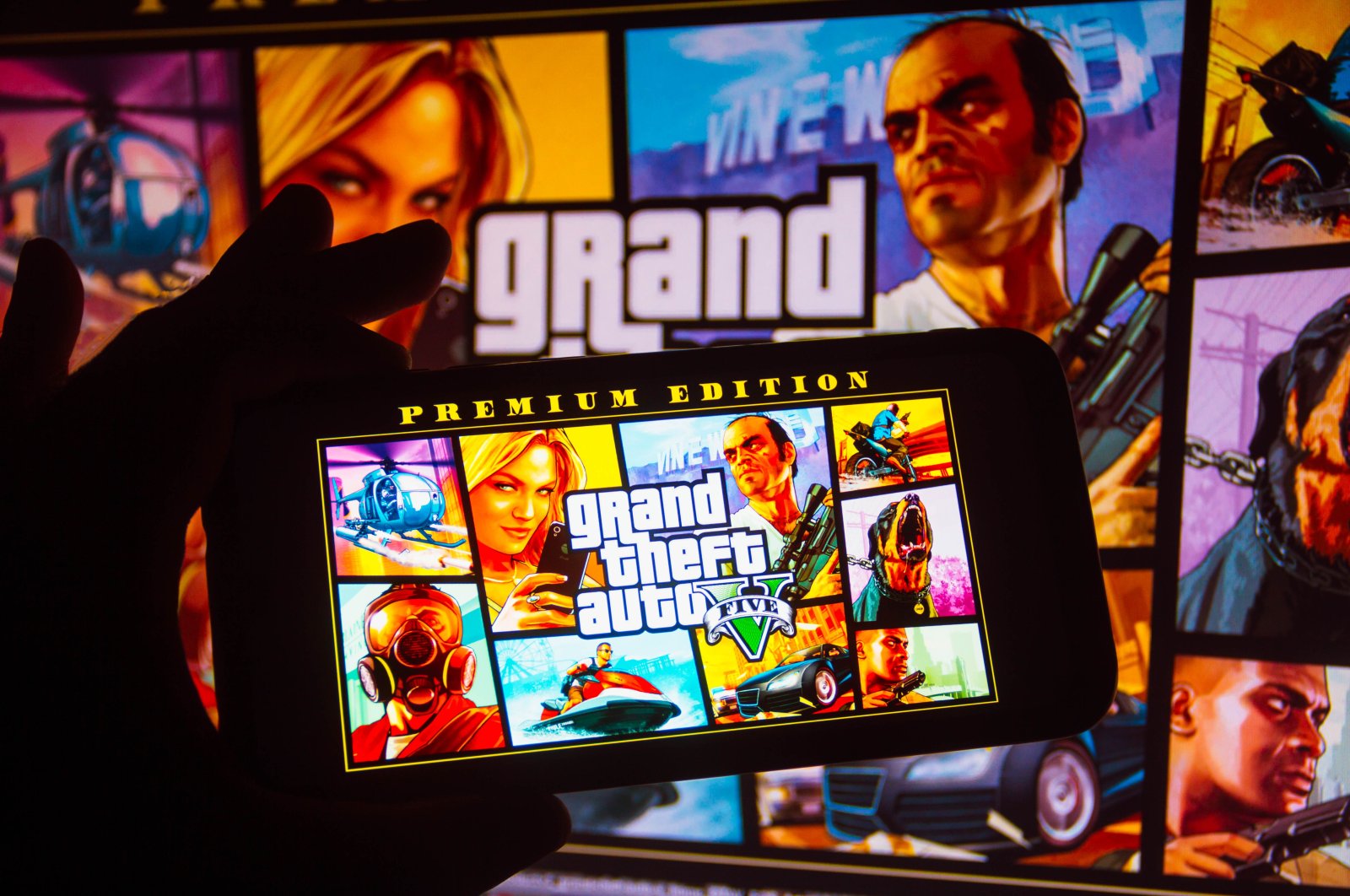 The Grand Theft Auto (GTA) logo is seen displayed on a smartphone in this photo illustration, Oct. 6, 2021. (Reuters Photo)