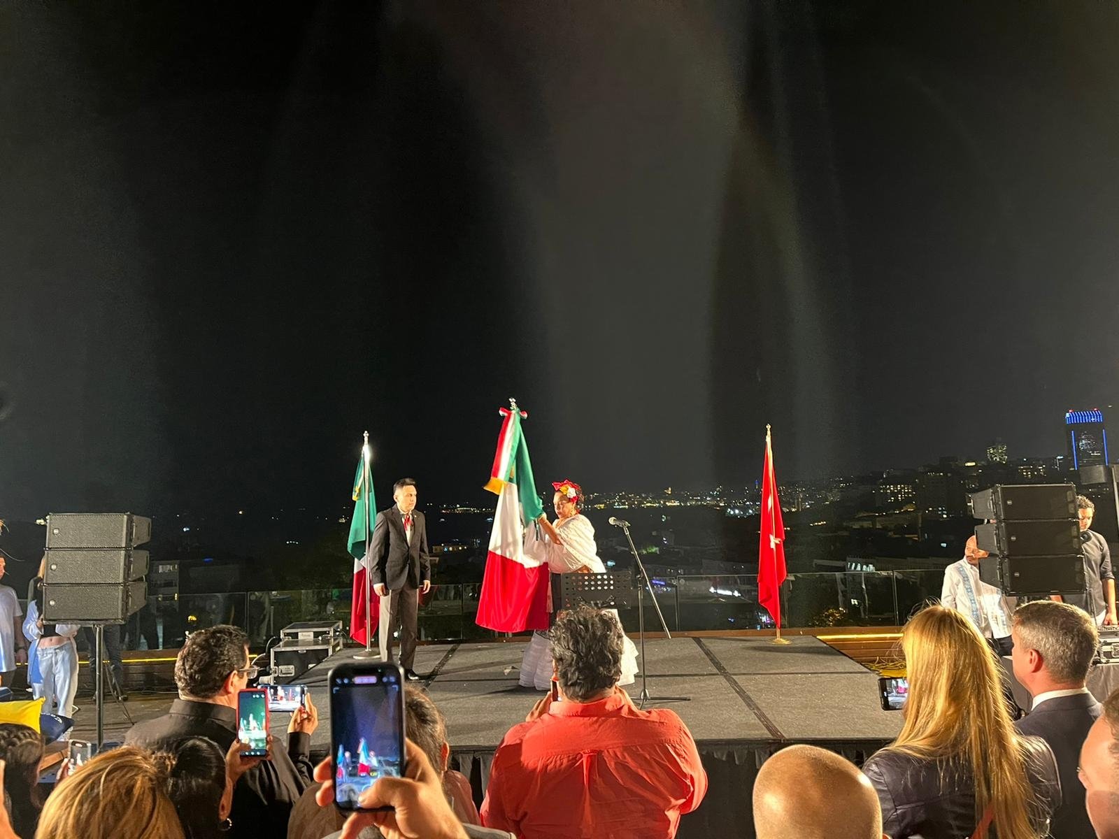 The Mexican Consulate&#039;s Istanbul Consul Isabel Arvide (R) and Deputy Consul Julio Escobado (L) waving the Mexican flag in the celebration, Istanbul, Türkiye, Sept. 16, 2022. (Photo by Buse Keskin)