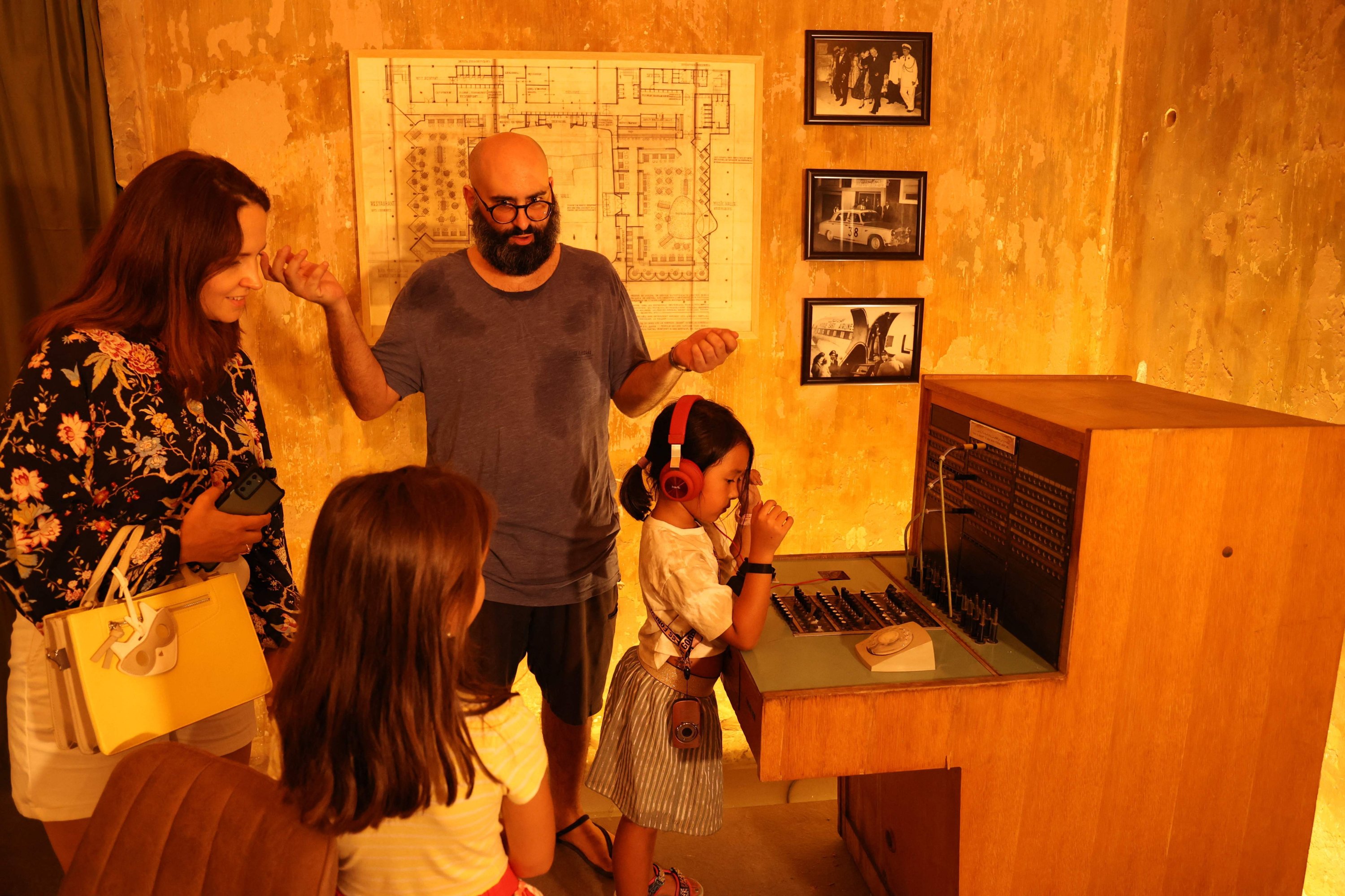 People in an exhibition titled "Allo, Beirut?," which shows archives of Lebanon's troubled past fused with artistic depictions of a grim present, at the capital's Beit Beirut heritage-house-turned-museum, Beirut, Lebanon, Sept. 15, 2022. (AFP Photo)