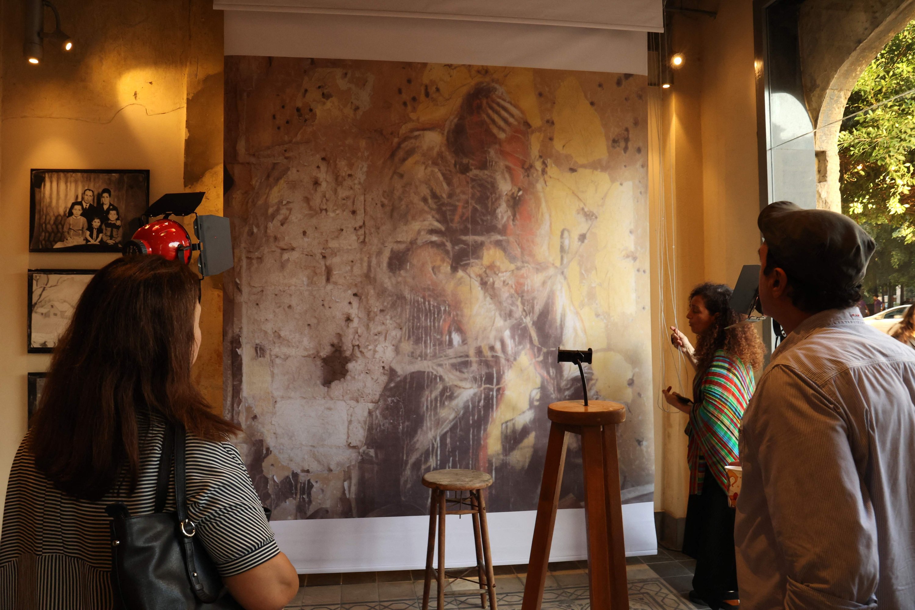 People in an exhibition titled "Allo, Beirut?," that shows archives of Lebanon's troubled past fused with artistic depictions of a grim present, at the capital's Beit Beirut heritage-house-turned-museum, Beirut, Lebanon, Sept. 15, 2022. (AFP Photo)
