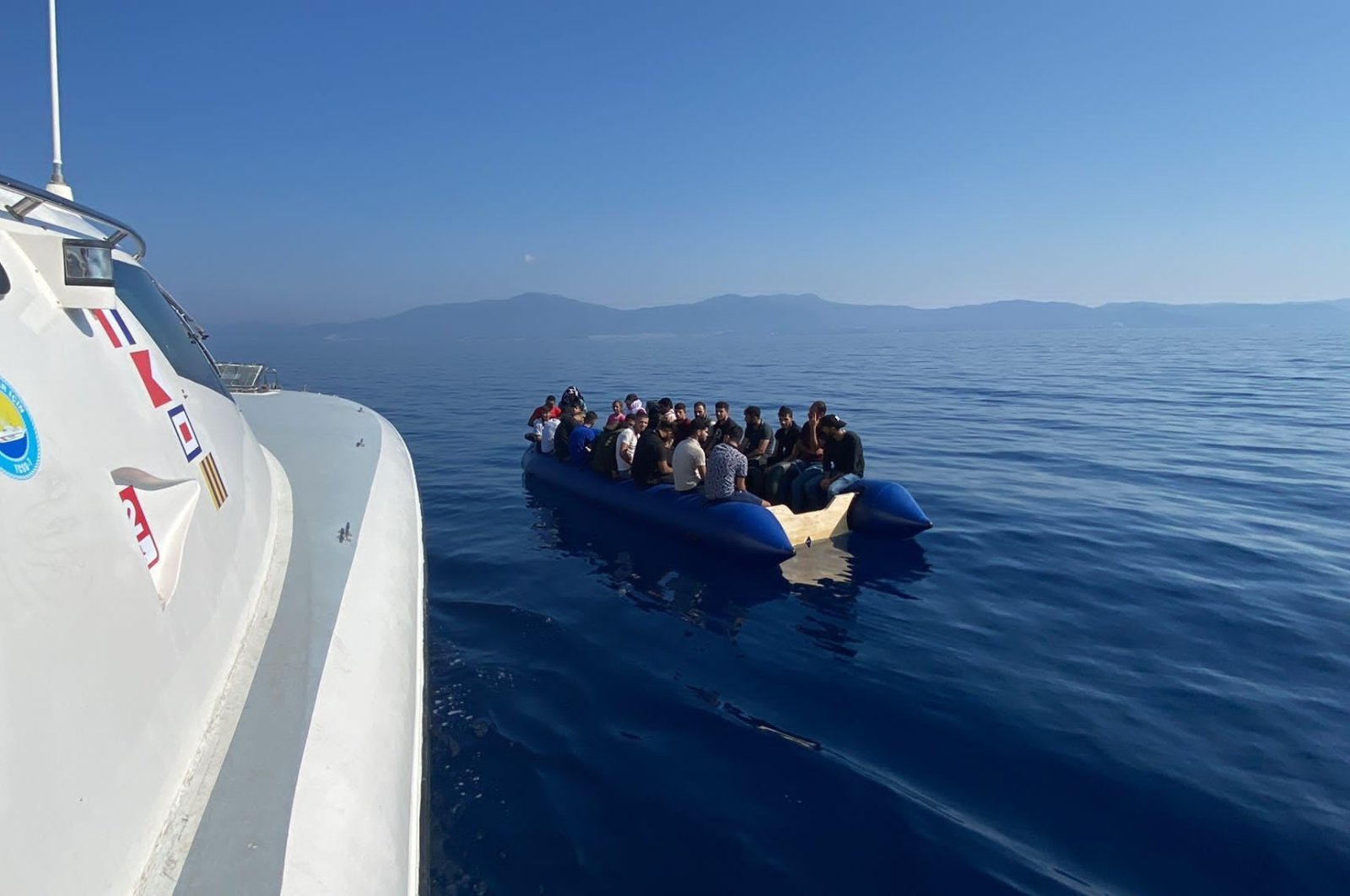 A Turkish coast guard boat approaches a migrant boat, in Izmir, western Türkiye, Sept. 6, 2022. (AA PHOTO)
