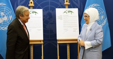 First lady Emine Erdoğan and U.N. Secretary-General Antonio Guterres pose in front of a goodwill agreement, in New York, U.S., Sept. 19, 2022. (AA PHOTO)