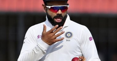 India's Virat Kohli shines the ball during a Test match against Bangladesh, Indore, India, Nov. 16, 2019. (AP Photo)