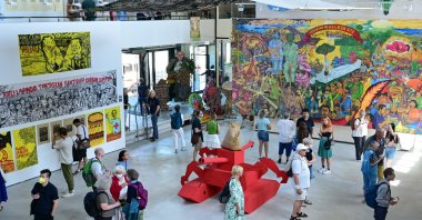Visitors stand in the Hallenbad-Ost, where the Indonesian artist collective Taring Padi is exhibiting, at documenta 15, Kessel, Germany, June 22, 2022. (dpa Photo)