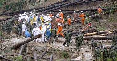 Rescue workers and Japanese troops conduct a search and rescue operation, Mimata, Japan, Sept. 19, 2022.