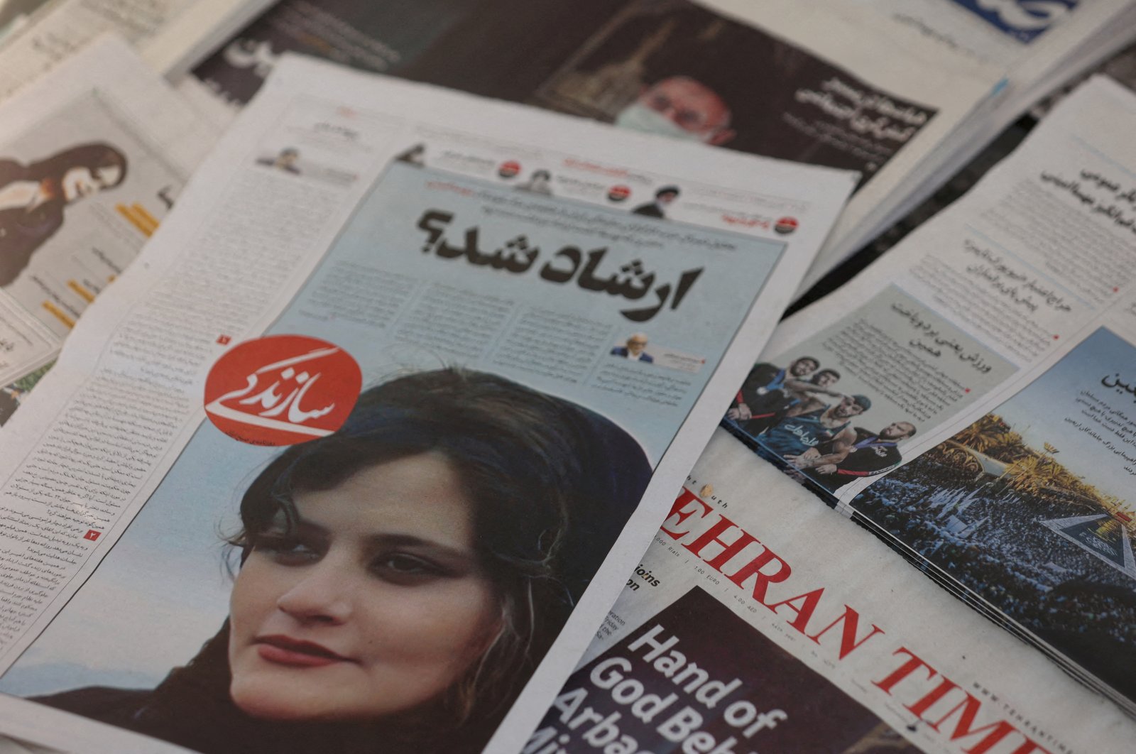 A newspaper with a cover picture of Mahsa Amini, a woman who died after being arrested by Iranian morality police, Tehran, Iran, Sept. 18, 2022. (Reuters Photo)