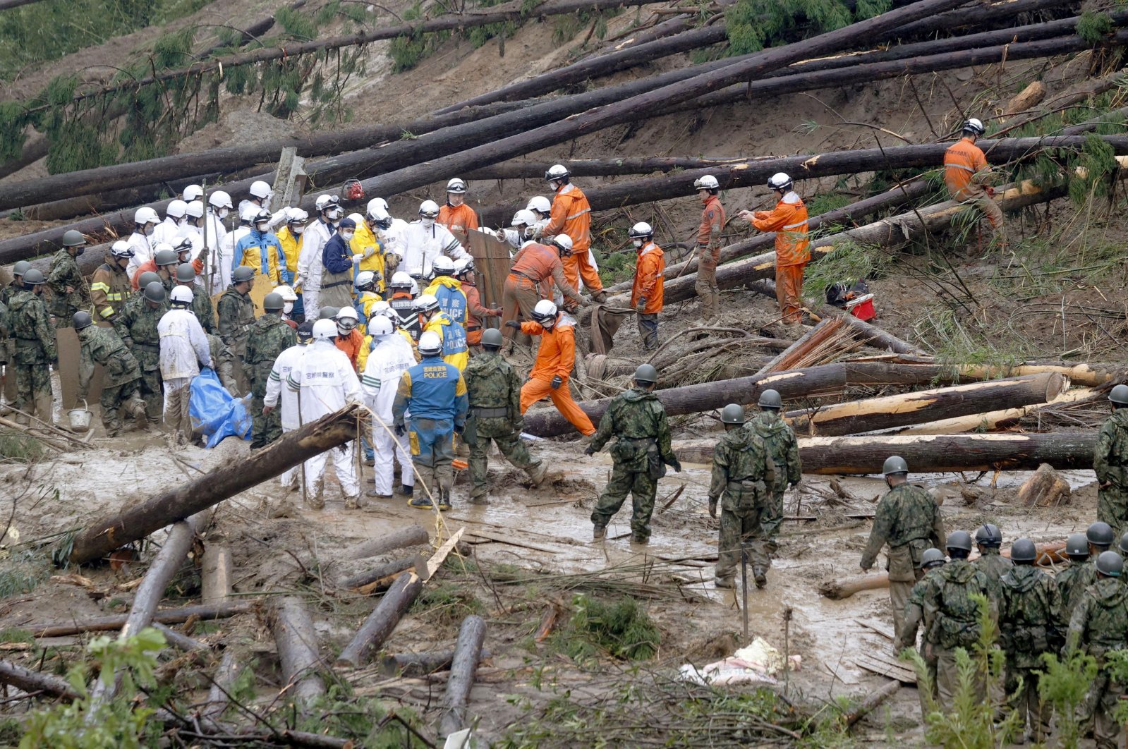 Rescue workers and Japanese troops conduct a search and rescue operation, Mimata, Japan, Sept. 19, 2022.