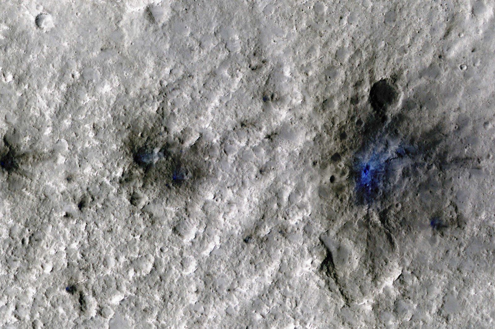 Craters formed by a Sept. 5, 2021, meteoroid impact on Mars, the first to be detected by NASA&#039;s InSight, are seen in an image taken by NASA&#039;s Mars Reconnaissance Orbiter. (Reuters Photo)