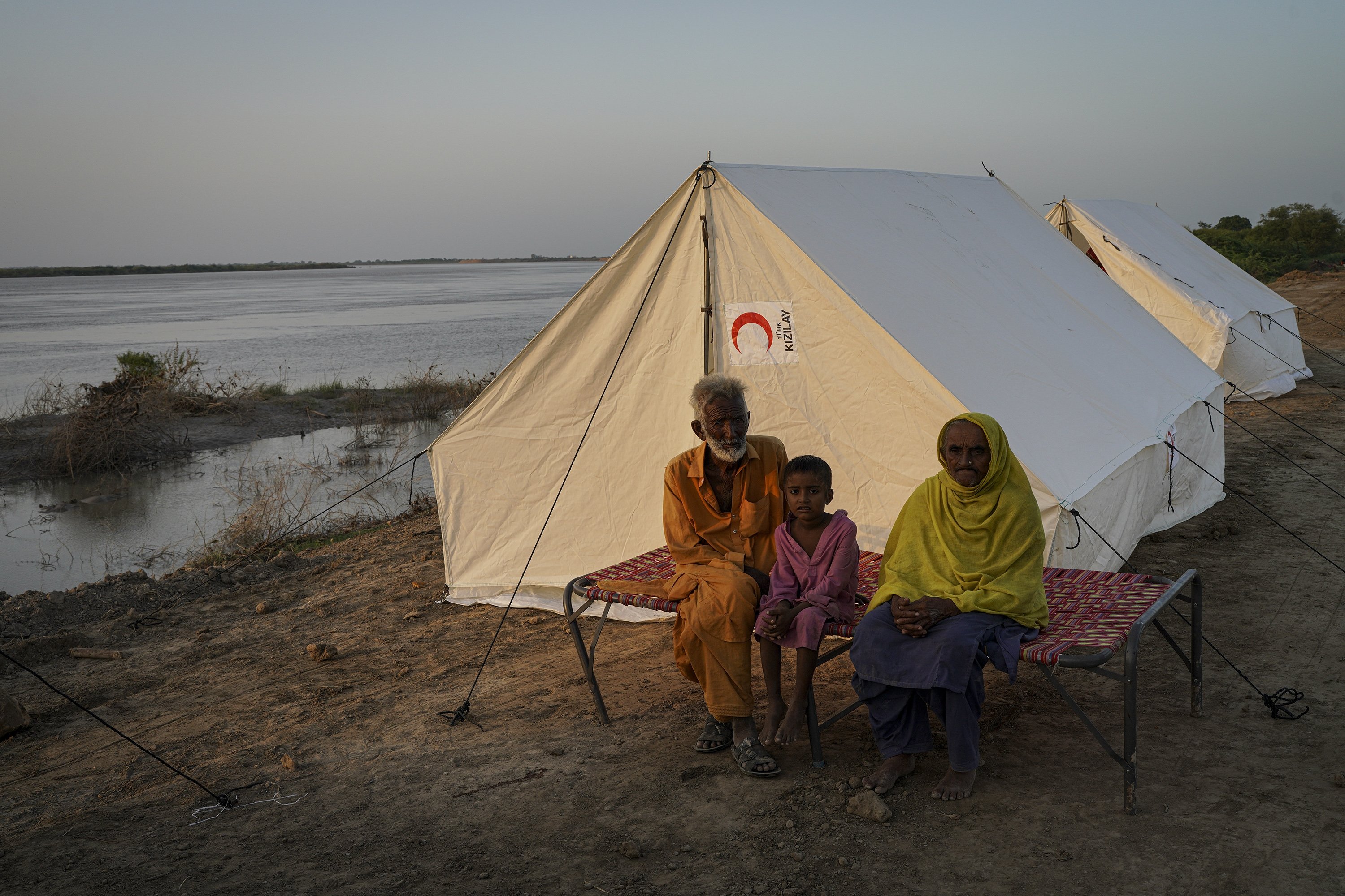 Displaced people sit outside their tent, in Sindh, Pakistan, Sept. 19, 2022. (PHOTO BY UĞUR YILDIRIM)