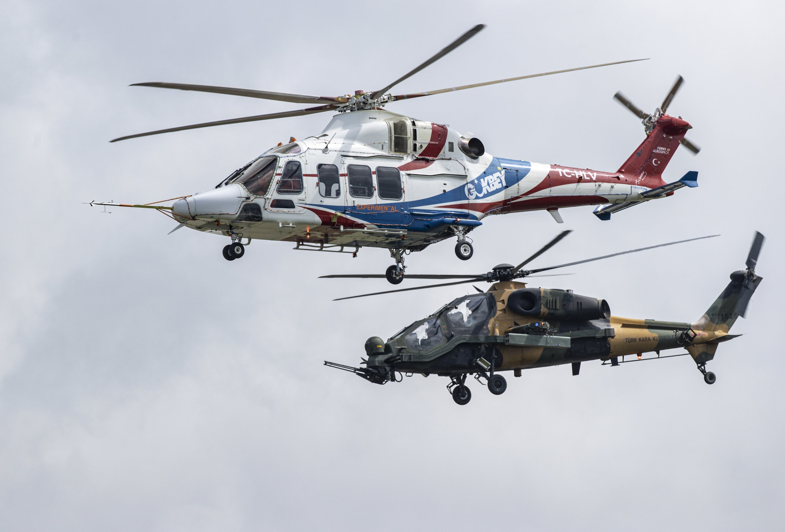 The multipurpose helicopter T-625 Gökbey (up) and T129 Tactical Reconnaissance and Attack Helicopters (ATAK) perform a flight during the Teknofest aerospace and technology festival in Samsun, northern Türkiye, Aug. 31, 2022. (AA Photo)