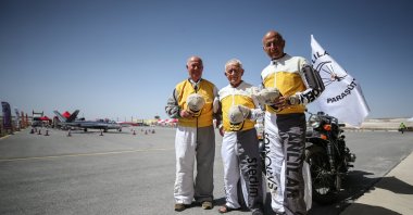 Ömer Erdem (L), Halit Öner (R) and Doğan Müjdat Süzen (C) pose on the sidelines of airshow, in Eskişehir, central Türkiye, Sept. 16, 2022. (AA PHOTO) 