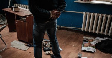 A man who has relatives in Russian-annexed Crimea talks in a room at the railway building where he says he was tortured by a militia in the so-called Luhansk People's Republic during Russia's occupation in March in the retaken town of Kozacha Lopan, Kharkiv region, Sept. 20, 2022. (AFP Photo)