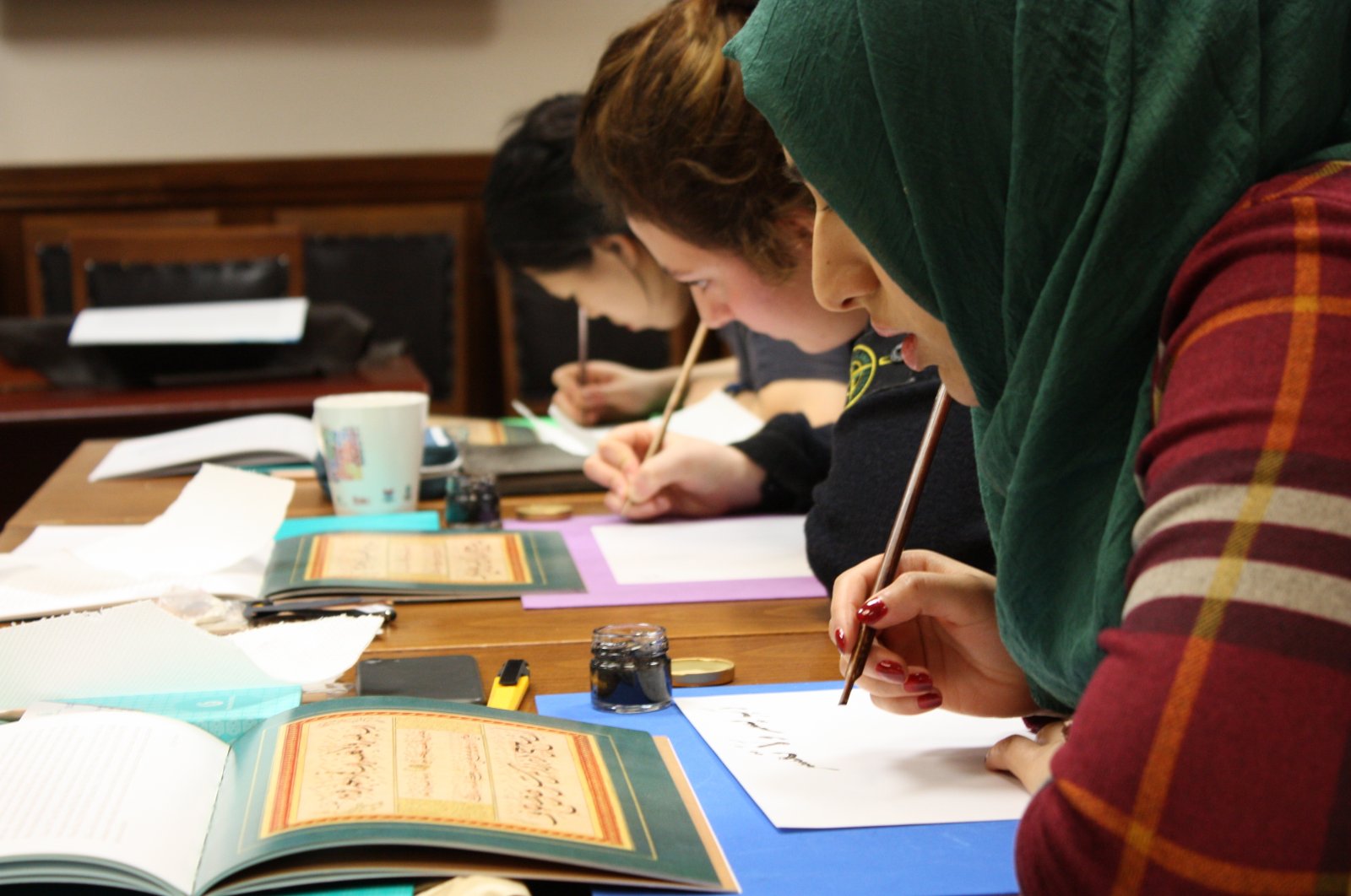 Students practice the art of calligraphy at the Yunus Emre Institute London, in London, U.K. (Photo courtesy of Yunus Emre Institute)