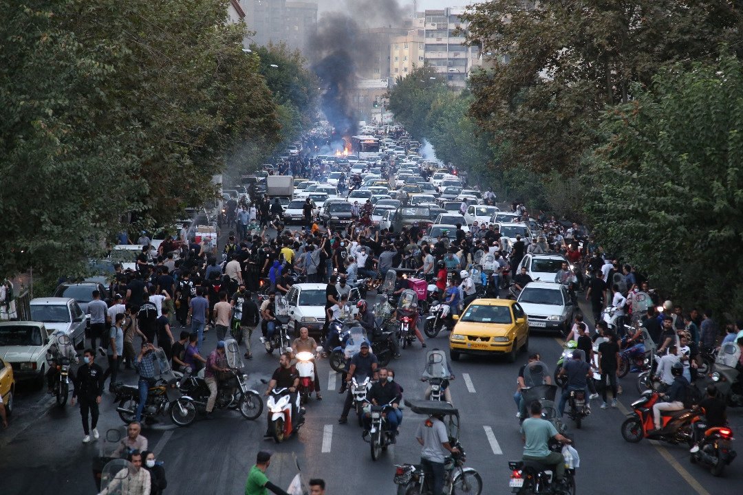 A picture obtained by AFP outside Iran on Sept. 21, 2022, shows Iranian demonstrators taking to the streets of the capital Tehran during a protest for Mahsa Amini, days after she died in police custody. (AFP Photo)