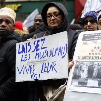 Protestors hold placards during a demonstration against islamophobia, in Paris, Sunday, Nov. 10, 2019. The placard on the left reads: "Let Muslims live their faith." (AP File Photo)
