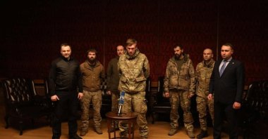 High-ranking members of Ukraine's Azov Battalion, Denys Prokopenko, Sviatoslav Palamar and Denys Shleha, stand next to Ukraine's intelligence chief Kyrylo Budanov as they speak to Ukrainian President Volodymyr Zelenskyy via video link after the prisoner swap, Ukraine, Sept. 22, 2022. (Reuters Photo)