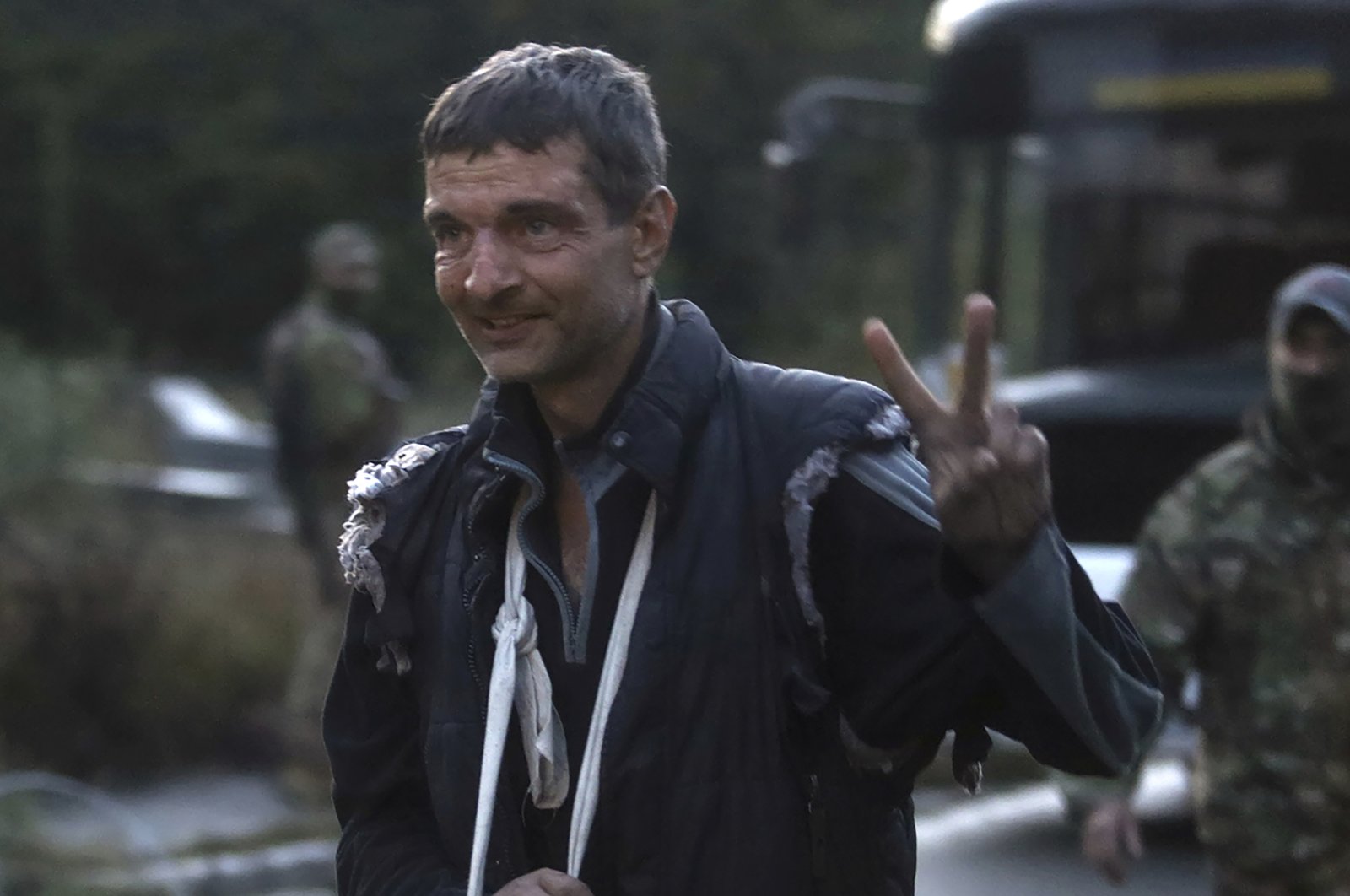 A Ukrainian soldier released in a prisoner exchange between Russia and Ukraine shows a V-sign close to Chernihiv, Ukraine, late Wednesday, Sept. 21, 2022. (Ukrainian Security Service Press Office via AP Photo)