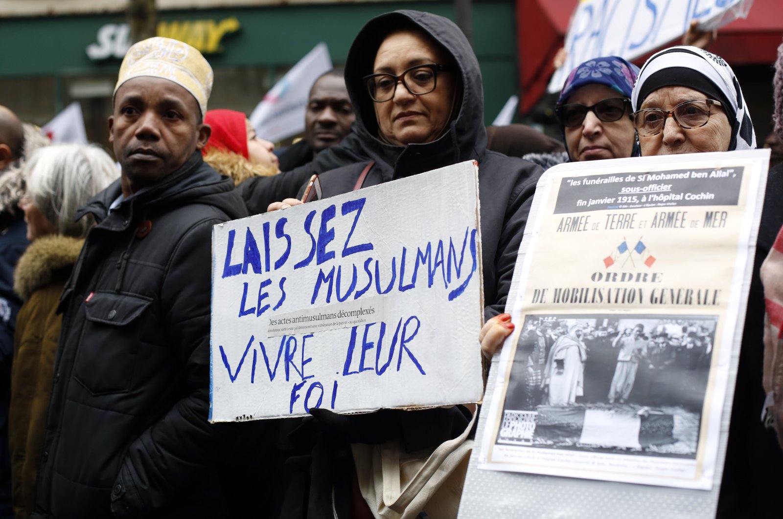 Protestors hold placards during a demonstration against islamophobia, in Paris, Sunday, Nov. 10, 2019. The placard on the left reads: "Let Muslims live their faith." (AP File Photo)