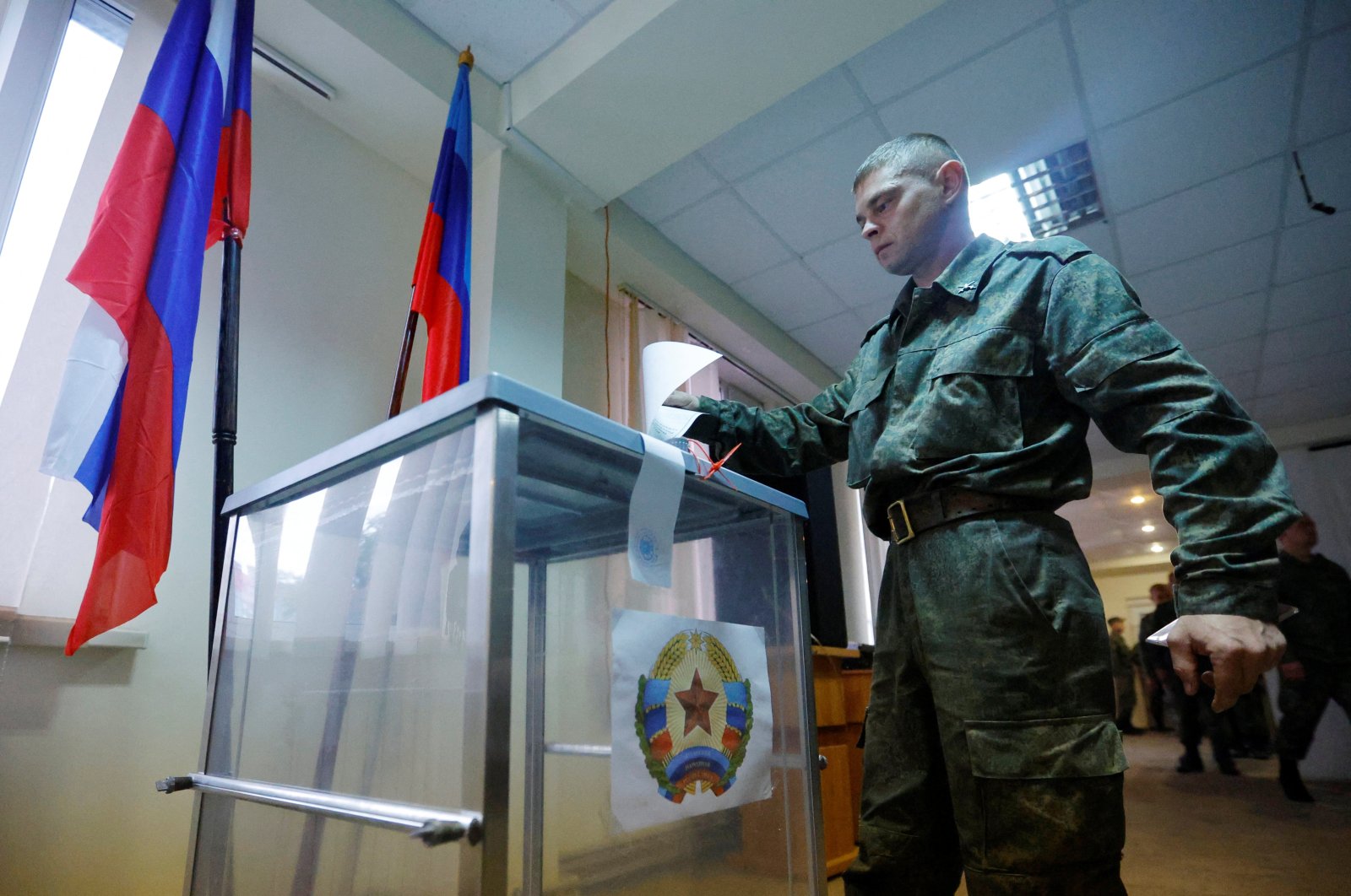 A service member of the self-proclaimed Luhansk People&#039;s Republic (LPR) votes during a referendum on joining LPR to Russia, Luhansk, Ukraine Sept. 23, 2022. (Reuters Photo)